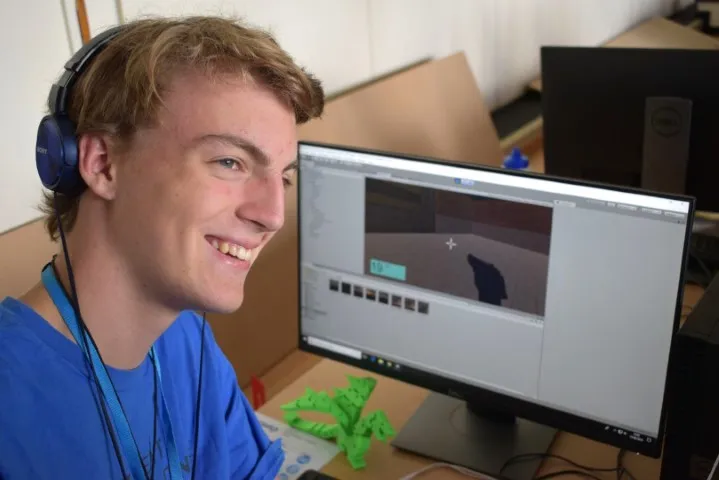 Tech Camper in front of 3D game he has designed