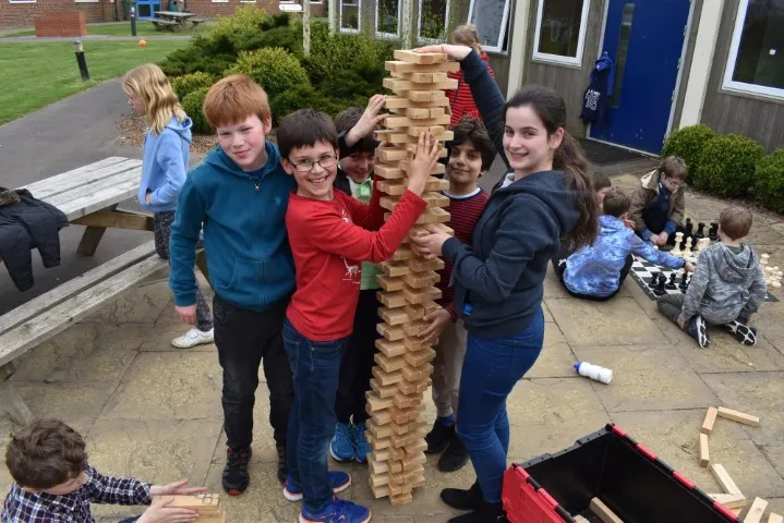 Children building using wood blocks at Tech Camp during a break