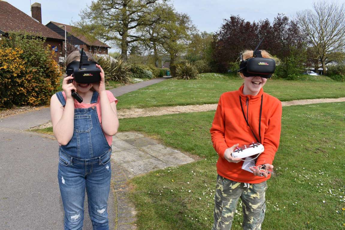 Two girls with VR headsets racing drones at Tech Camp