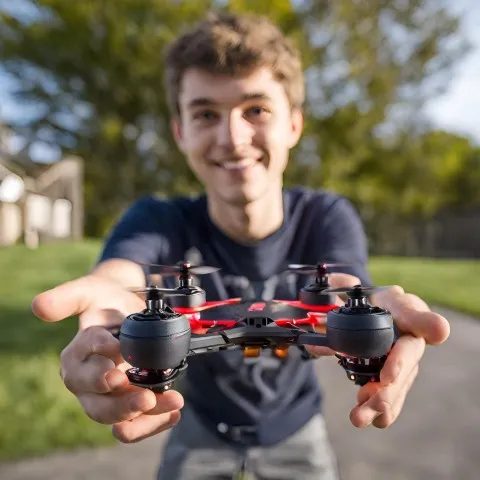 Boy holding up drone to camera