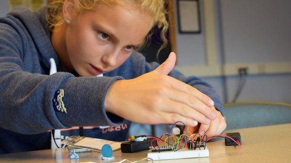 Girl inventing with electronics